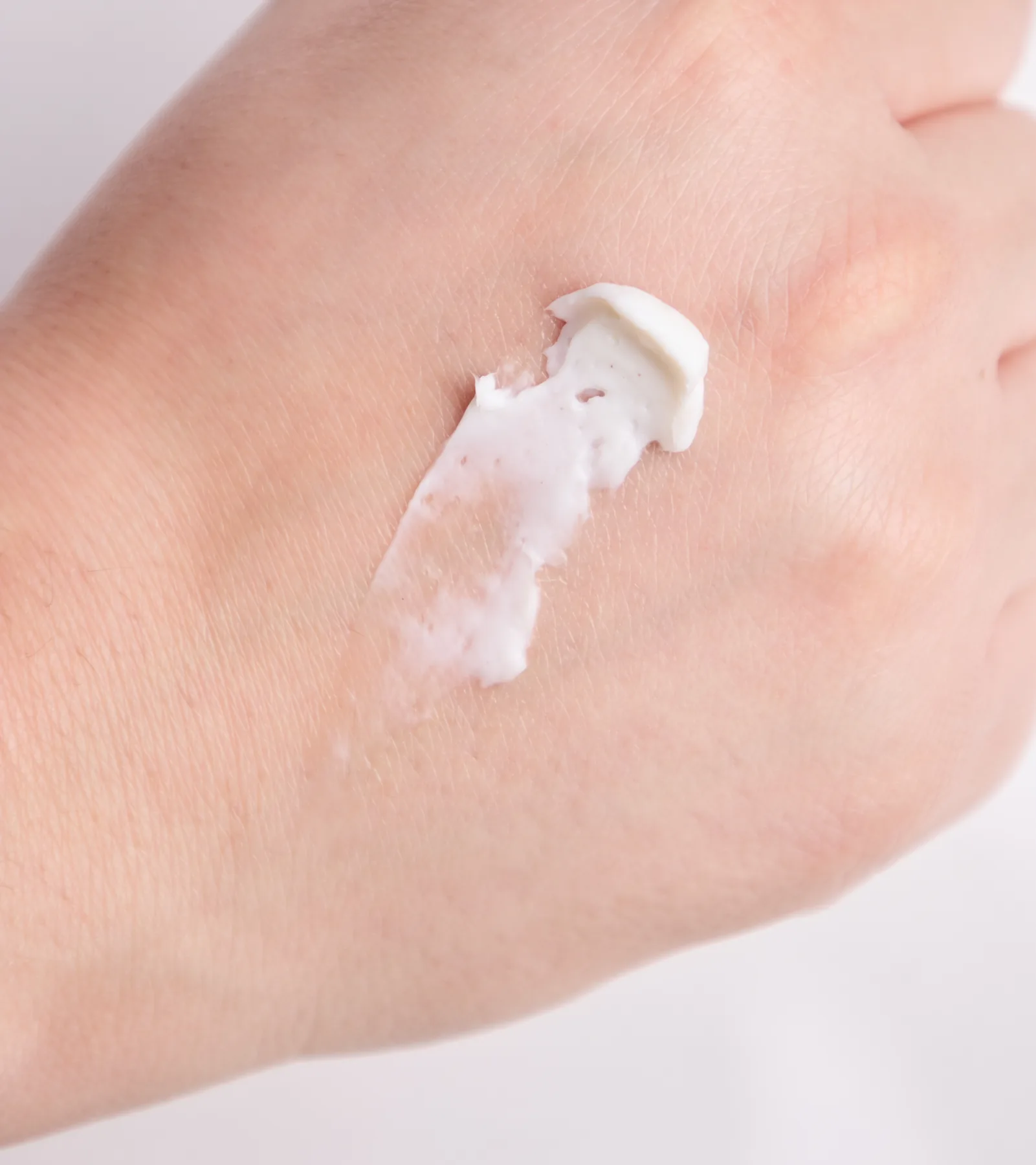 A swatch of The Peptide Cream on the back of a hand